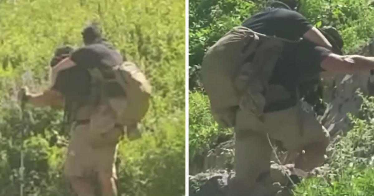 Bergsteiger schauen sich den Rucksack eines Mannes genauer an und erkennen, dass er einen Marinesoldaten trägt, der im Kampf verletzt wurde.